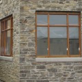 The exterior walls of a home outfitted with Charcoal Weatheredge stone veneer from Halquist's Ledge Collection.