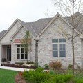 The exterior walls of a home outfitted with Chilton Cobblefield stone veneer from Halquist's Ledge Collection.