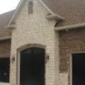 The exterior walls of a home outfitted with Fond Du Lac Cobblefield stone veneer from Halquist's Ledge Collection.