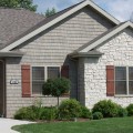 The exterior walls of a home outfitted with Fond Du Lac Ledge stone veneer from Halquist's Ledge Collection.