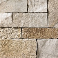 A light grey and tan stone veneer withbrown accents perfect for any hardscape idea on the exterior or interior of any home or landscape.