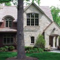 The exterior walls of a home outfitted with Hamilton Buff stone veneer from Halquist's Castlestone Collection.