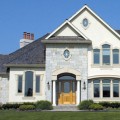 The exterior walls of a home outfitted with Hamilton Grey stone veneer from Halquist's Castlestone Collection.