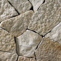 A light colored mosaic-style webwall building stone featuring white and light gray with golden and tan accents. Perfect for any idea inside or outside of the home.