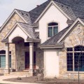 The exterior walls of a home outfitted with Mayfair Full Color stone veneer from Halquist's Castlestone Collection.