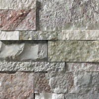 A grey stone veneer with a few pink and green accents perfect for any hardscape idea on the exterior or interior of any home or landscape.