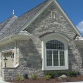 The exterior walls of a home outfitted with Plum Creek Dimensional stone veneer from Halquist's Castlestone Collection.