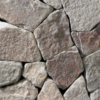 a light grey webwall-style building stone with gold and darker-gray accents.