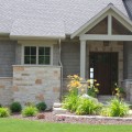 The exterior walls of a home outfitted with the Sandhill Creme stone veneer from Halquist's Ledge Collection.