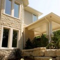 The exterior walls of a home outfitted with Sonoma Tumbled stone veneer from Halquist's Castlestone Collection.