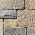 A tumbled cool-grey stone veneer with tan accents perfect for any hardscape idea on the exterior or interior of any home or landscape.