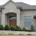 The exterior walls of a home outfitted with Tumbled Silverledge stone veneer from Halquist's Ledge Collection.