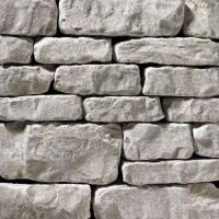 A light grey, tumbled stone veneer perfect for any hardscape idea on the exterior or interior of any home or landscape.