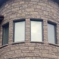 The exterior wall of a building outfitted with Waukesha Brown stone veneer from Halquist's Castlestone Collection.