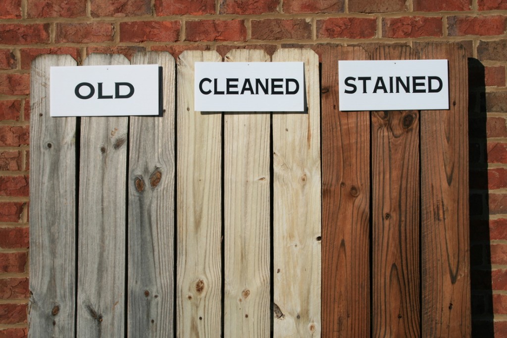 a photo showcasing three sets of planks. One old and dirty, one cleaned, and the last stained.