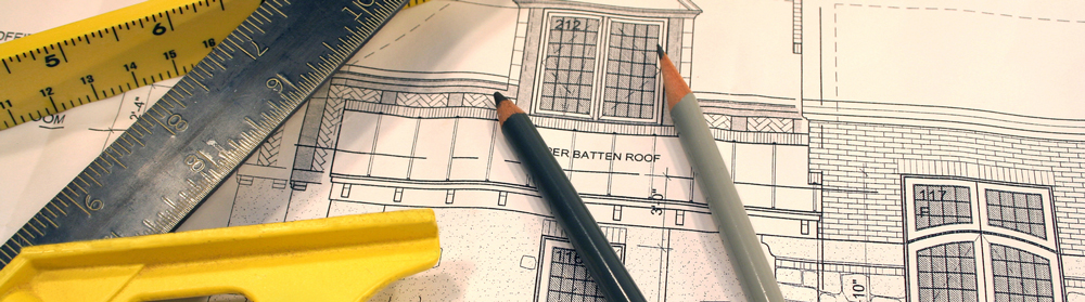 pencils, blueprints, a level, and ruler to depict home improvement.